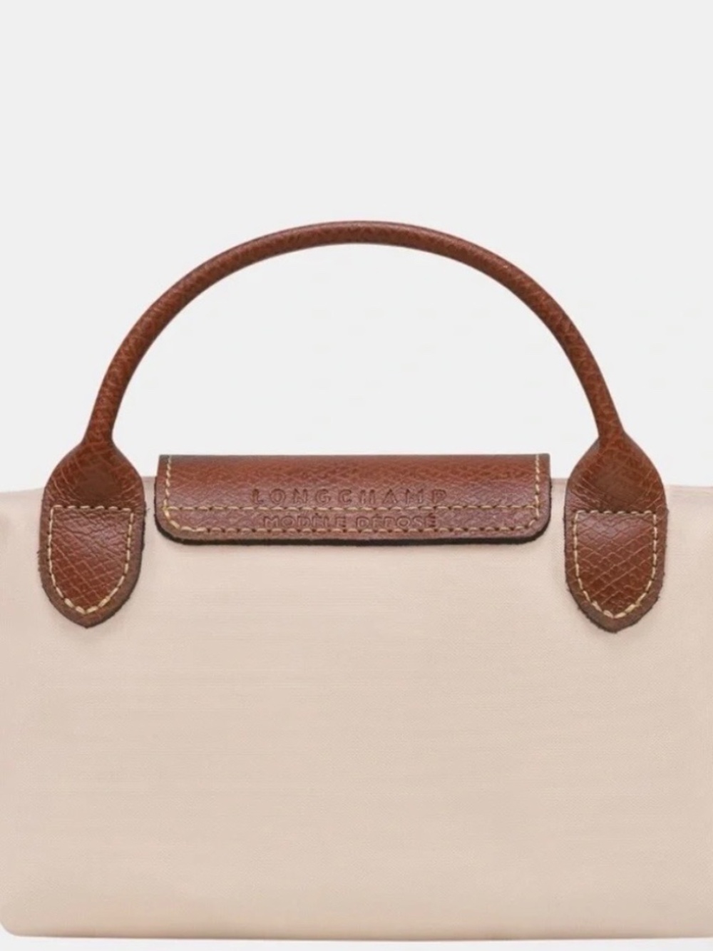 Compact cream nylon mini tote. Brown leather flap and top handle. Gold-tone butt - Picture 2 of 5
